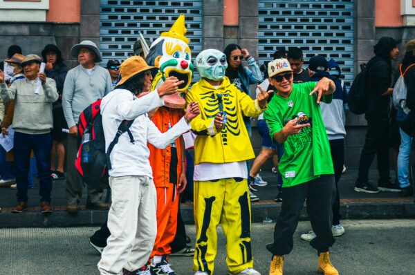 Participants in vibrant costumes celebrate International Workers’ Day at a parade in Quito, Ecuador, creating a lively atmosphere.