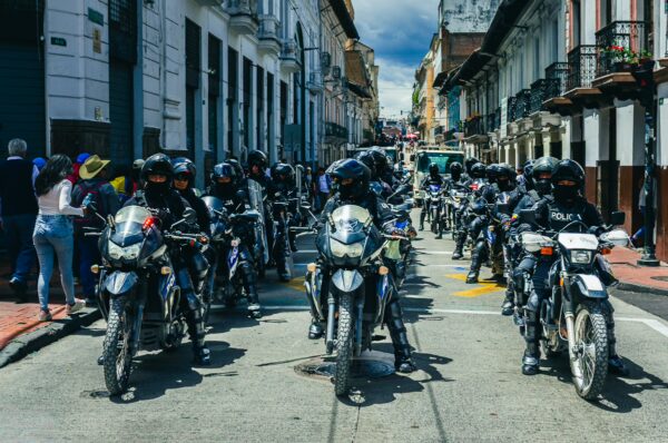 Motorcyclists in helmets line the street during the International Workers' Day parade in Quito, Ecuador, 2026.