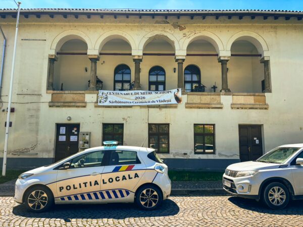 Craiova's ethnographic museum features a historic building with arches and a local police car parked in front.