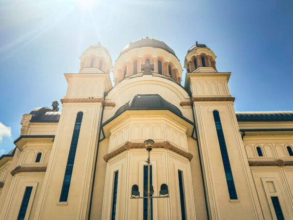 Stunning view of the Church of Our Lady in Craiova, Romania, showcasing its intricate architecture and bright blue sky.