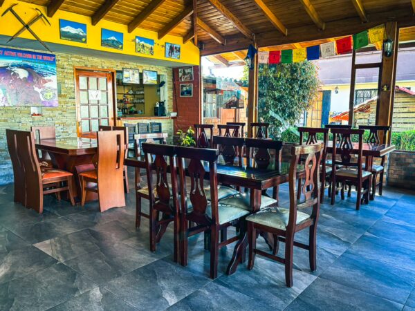 Bright and inviting interior of Casa del Montanero, featuring wooden tables, colorful decor, and a cozy dining atmosphere in Machachi, Ecuador.