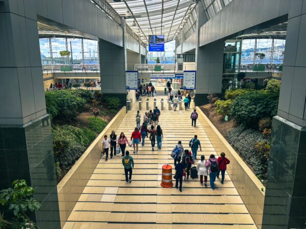 Buzzing atmosphere at Quitumbe Terminal Terrestre in Quito, Ecuador, featuring travelers navigating the spacious terminal layout.