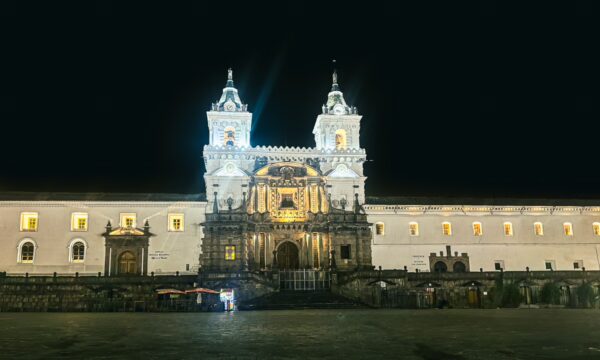 Stunning night view of San Francisco Square featuring illuminated buildings and architectural details in Quito, Ecuador.