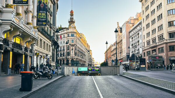 Teatro Alcázar stands elegantly on Gran Vía, Madrid, showcasing vibrant architecture and a lively urban atmosphere.