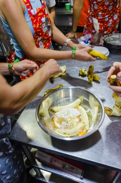 Cooking class hands chopping vegetables at a table in Salento, Colombia