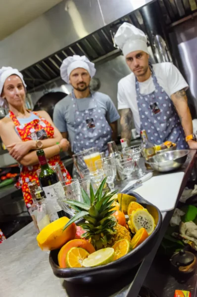 Cooking class in Salento, Colombia, chefs in aprons and caps with fruit and vegetables on the table