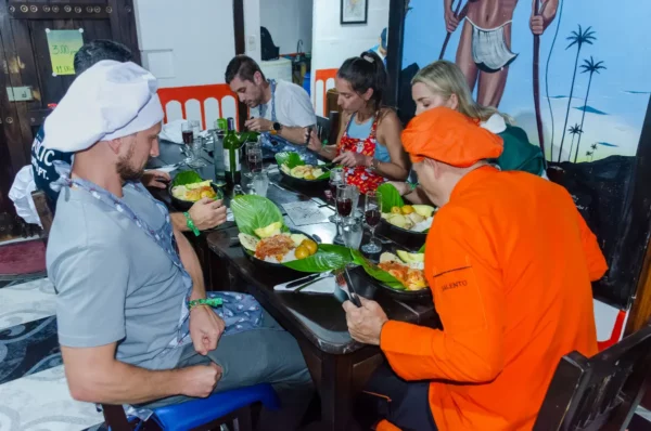 Cooking class, Salento Colombia: travelers prepare food at a table with green plates and drinks
