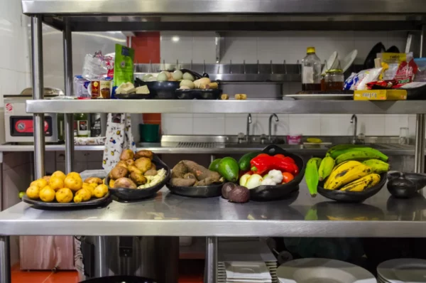 Cooking-class kitchen prep in Salento, Colombia, with peppers, bananas, potatoes, and eggs on counters